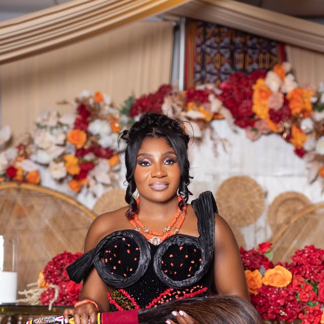 Bride in traditional African wedding attire with coral beadwork